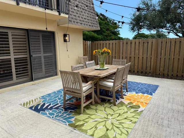 a view of backyard with a patio and outdoor seating