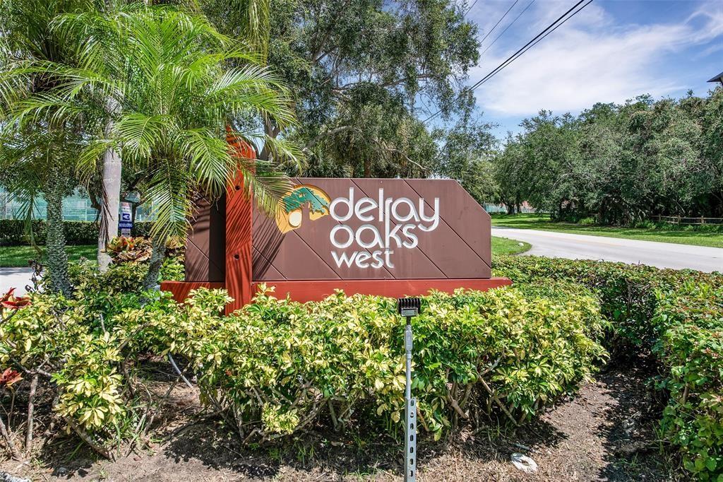 2911 Southwest 22nd Circle, Unit 37B Delray Beach, FL 33445 - Photo 43 of 51 a sign that is sitting in front of a tree