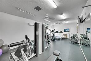 2911 Southwest 22nd Circle, Unit 37B Delray Beach, FL 33445 - Photo 49 of 51 a view of a room with gym equipment