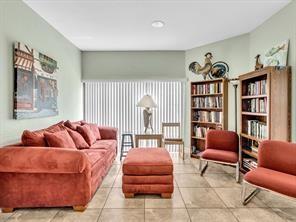 2911 Southwest 22nd Circle, Unit 37B Delray Beach, FL 33445 - Photo 51 of 51 a living room with furniture and a book shelf