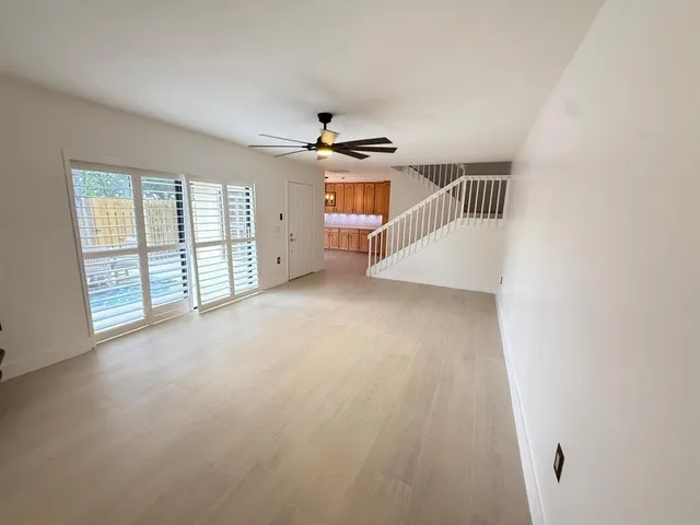 a open kitchen with stainless steel appliances granite countertop a refrigerator a sink dishwasher stove and wooden cabinets