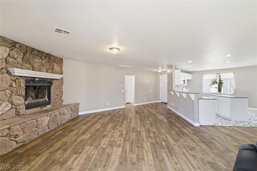 2780 West Simkins Road Pahrump, NV 89060 - Photo 8 of 40 A spacious living area combines modern finishes with a striking stone fireplace.