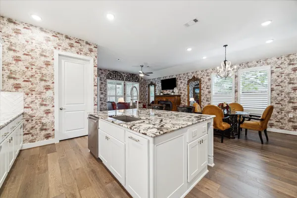 a kitchen with stainless steel appliances granite countertop a stove oven and a refrigerator