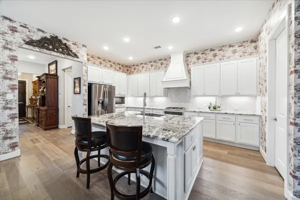 a kitchen with a sink stove and cabinets