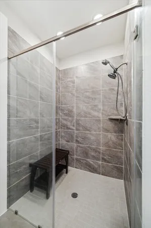 a bathroom with a shower and a sink