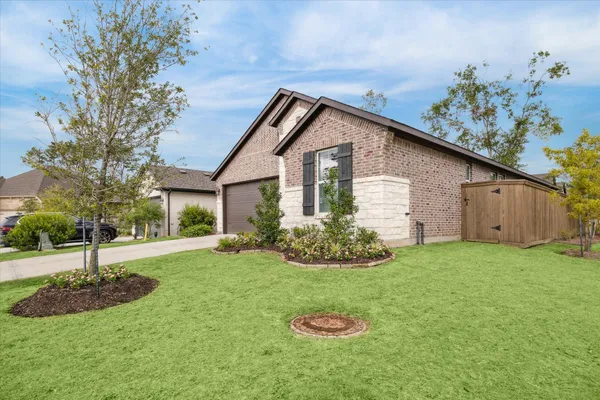 a view of a house with yard and green space