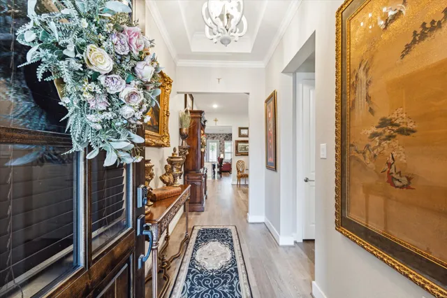 a view of a hallway with wooden floor and stairs