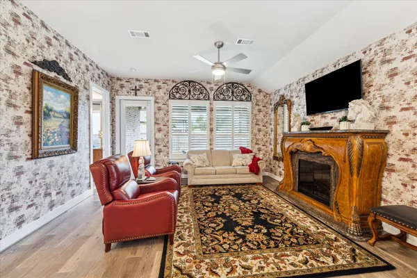 a living room with fireplace furniture and a flat screen tv