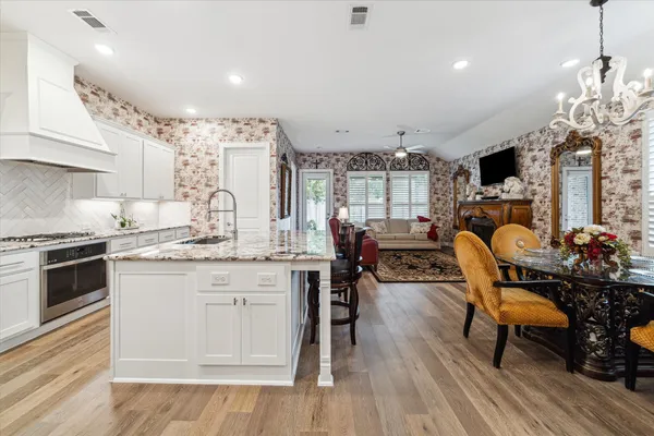 a living room with furniture a dining table and kitchen view