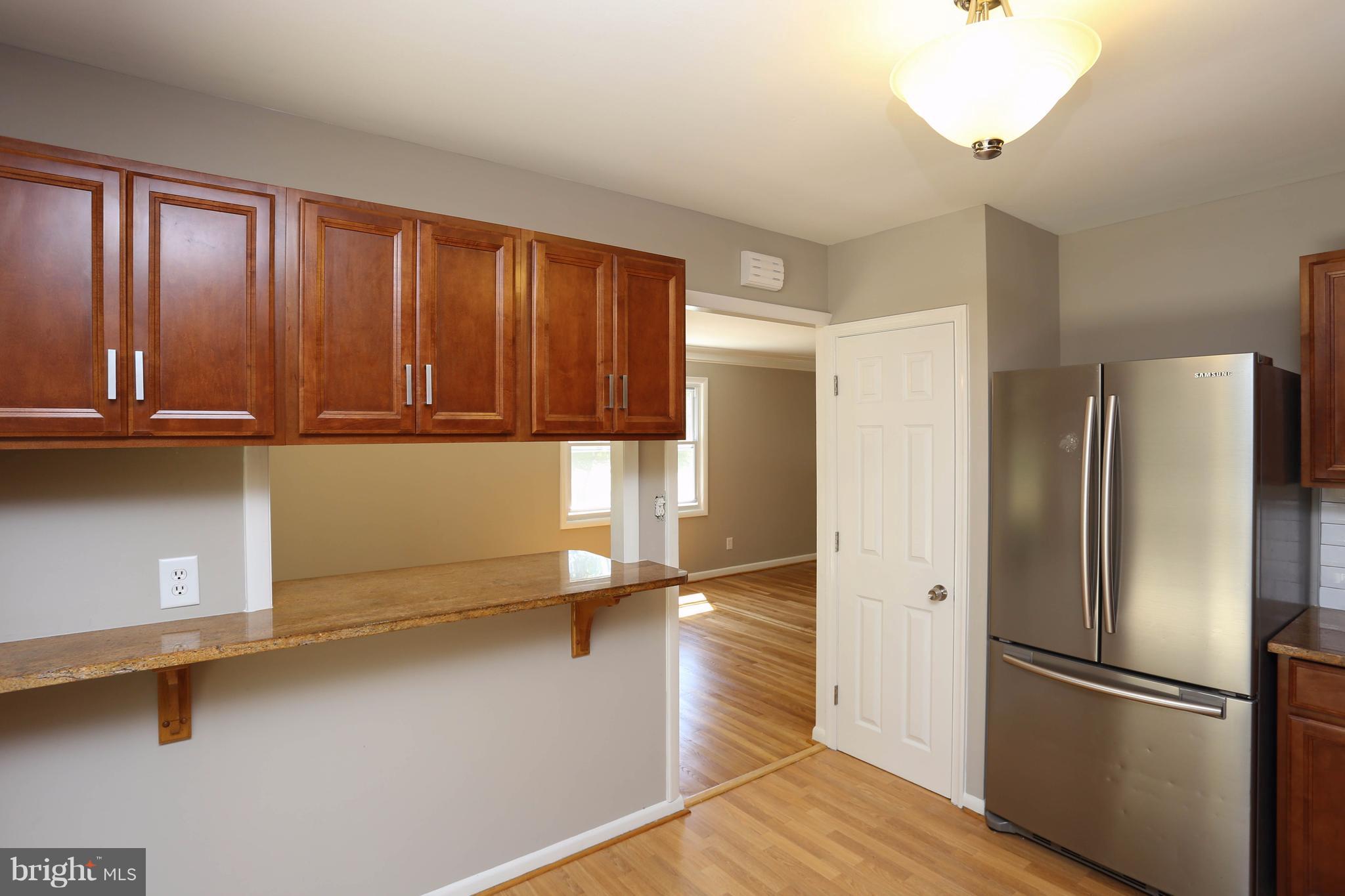 512 Crosby Road Baltimore, MD 21228 - Photo 11 of 30 a kitchen with stainless steel appliances a refrigerator and cabinets