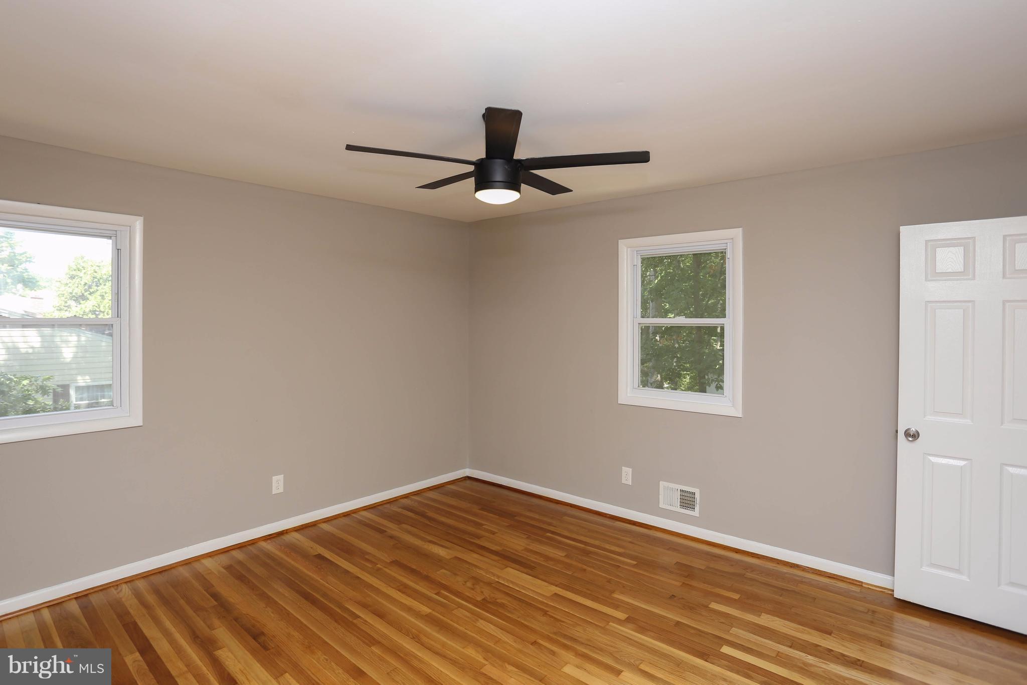512 Crosby Road Baltimore, MD 21228 - Photo 13 of 30 wooden floor in an empty room with a window