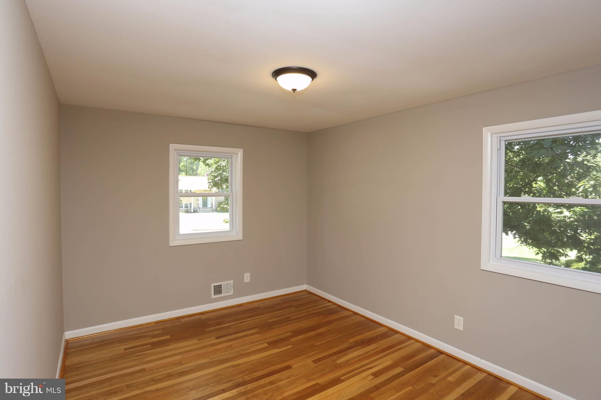 512 Crosby Road Baltimore, MD 21228 - Photo 15 of 30 a view of a room with wooden floor and windows