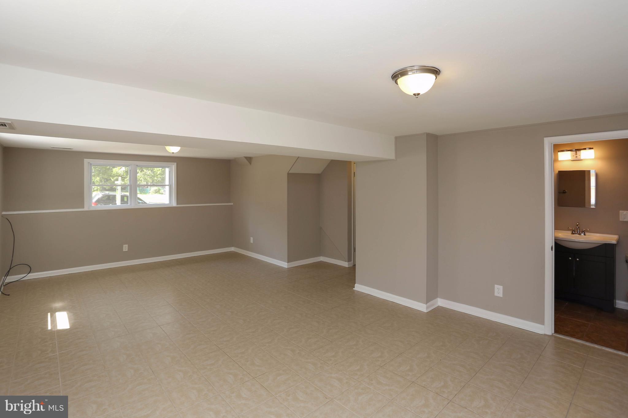 512 Crosby Road Baltimore, MD 21228 - Photo 23 of 30 an empty room with windows and entrance