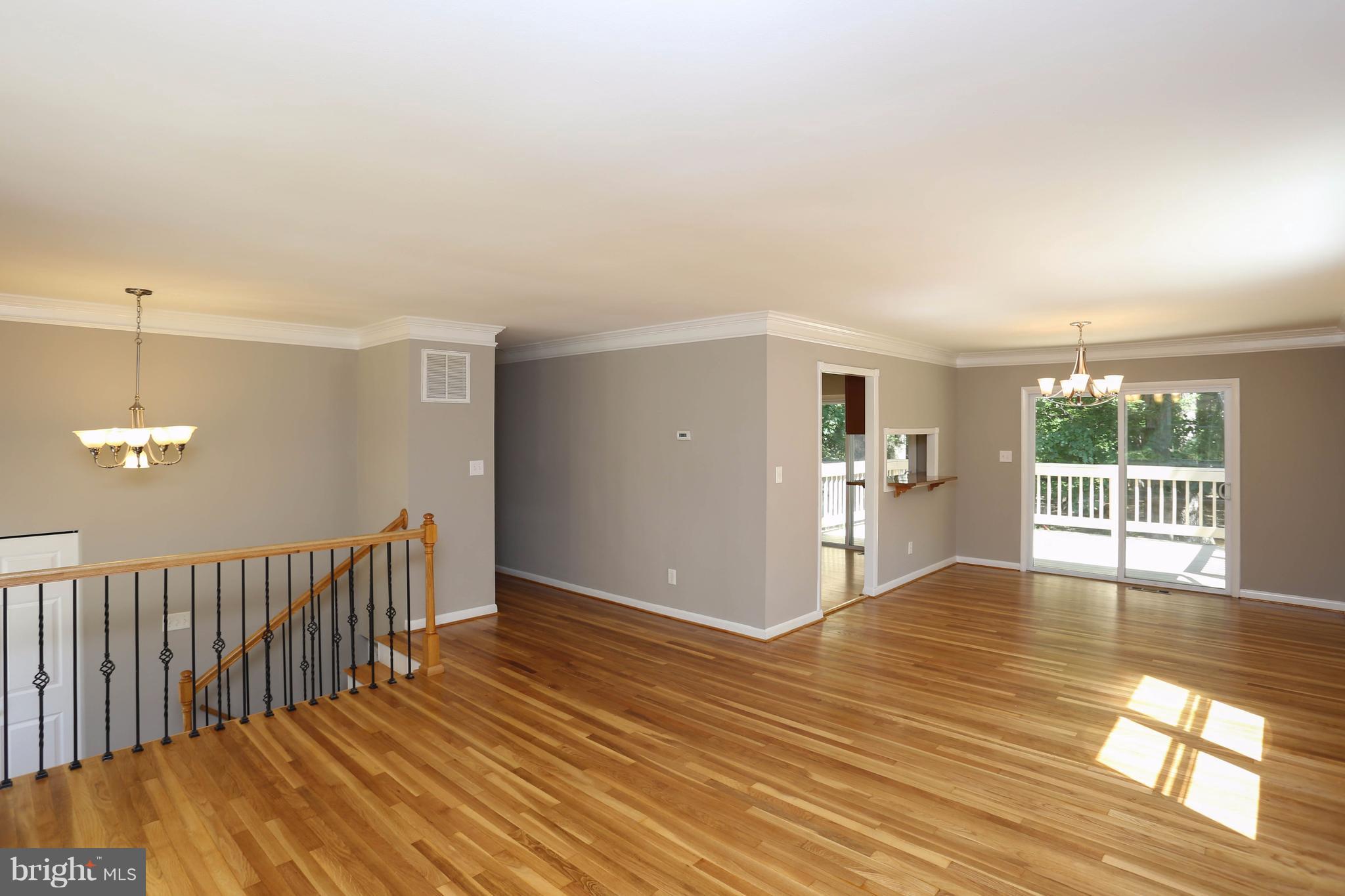 512 Crosby Road Baltimore, MD 21228 - Photo 4 of 30 a view of an empty room with wooden floor and a window