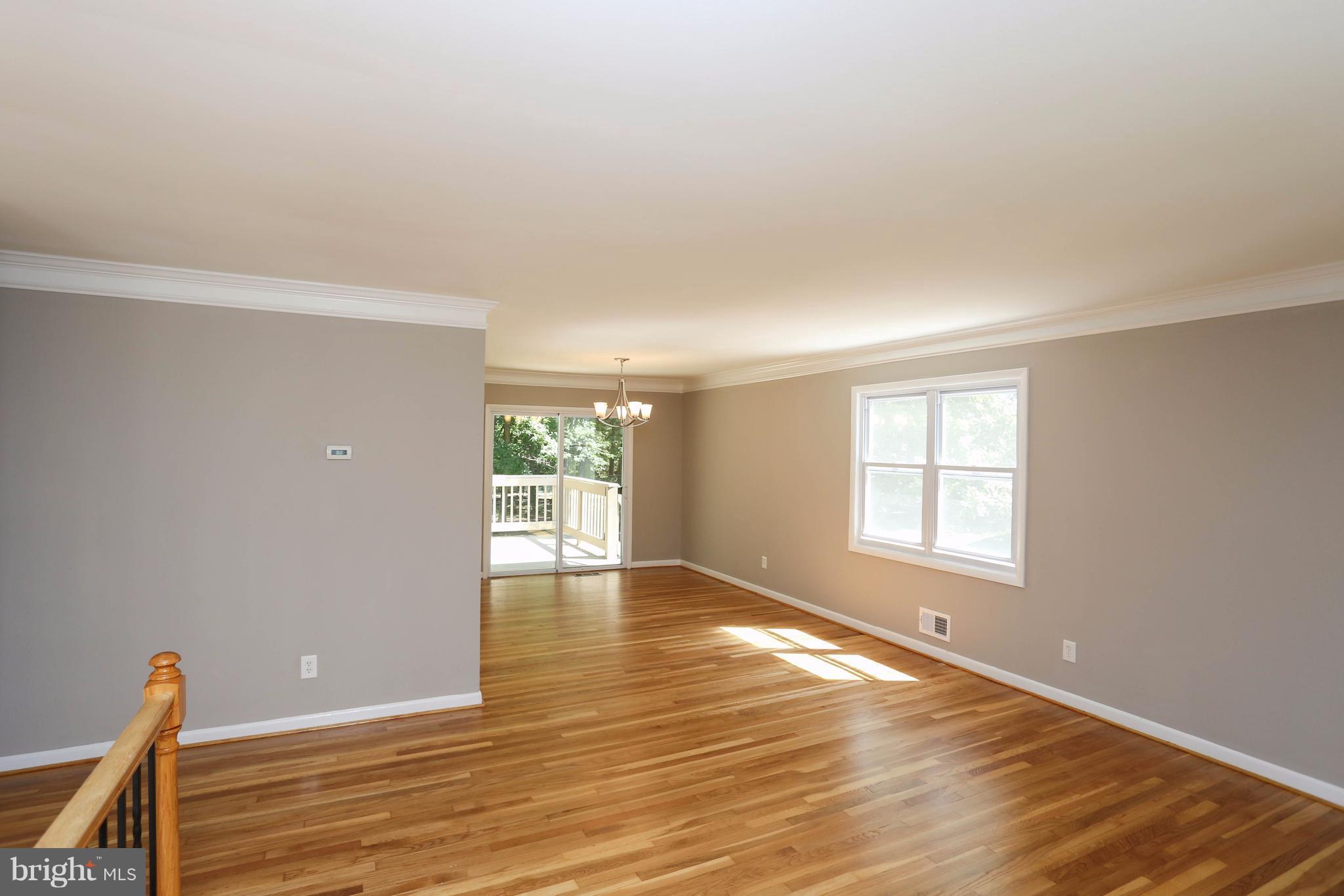 512 Crosby Road Baltimore, MD 21228 - Photo 5 of 30 wooden floor in an empty room with a window