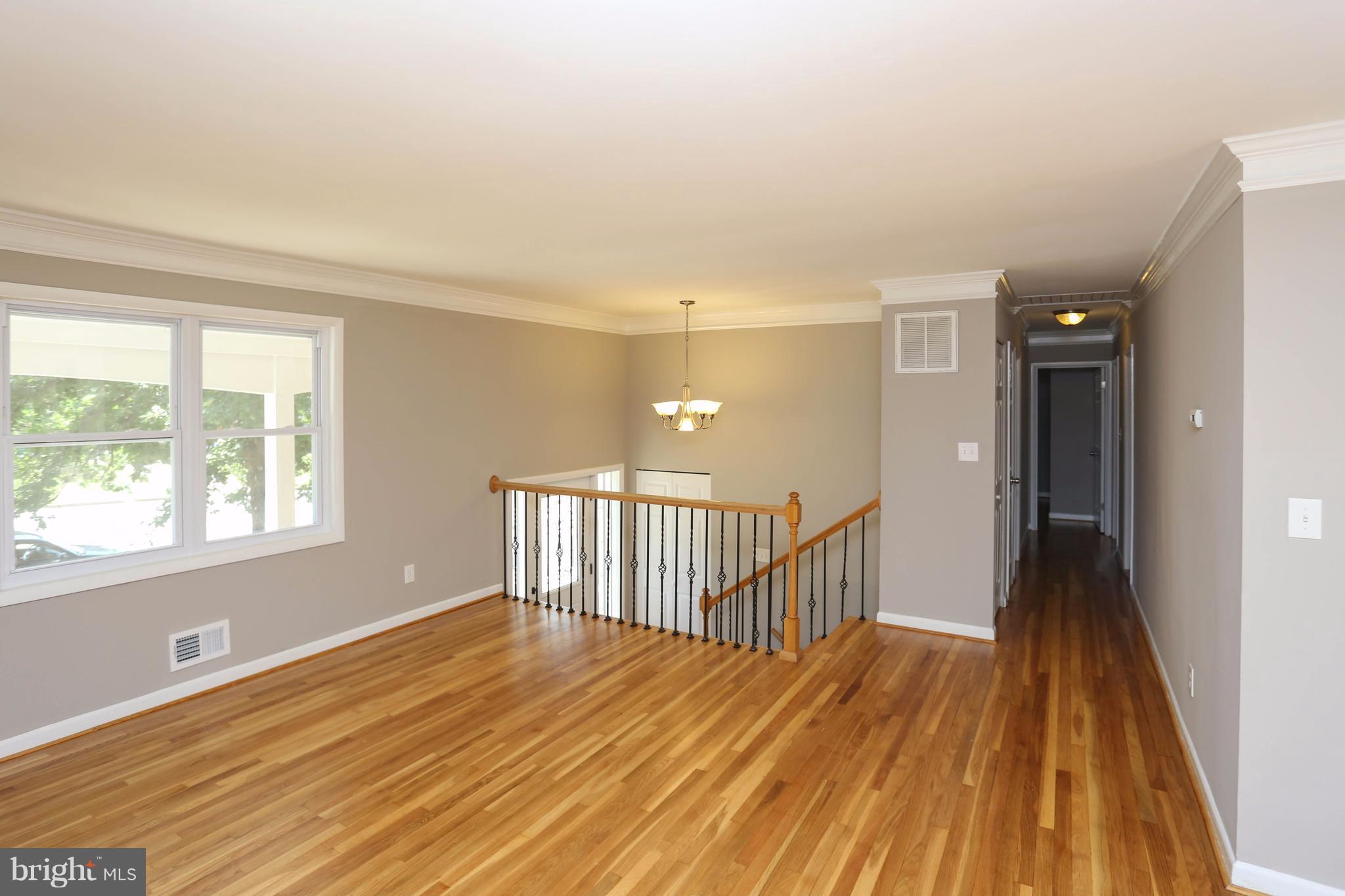 512 Crosby Road Baltimore, MD 21228 - Photo 6 of 30 a view of a room with wooden floor and windows