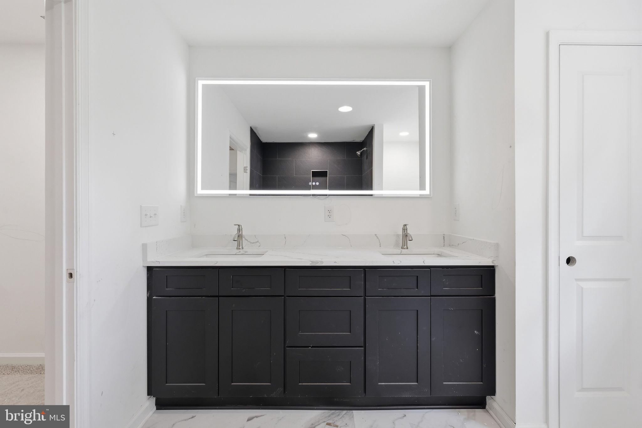 10339 Back Creek Valley Road Hedgesville, WV 25427 - Photo 28 of 48 a bathroom with a sink vanity and mirror