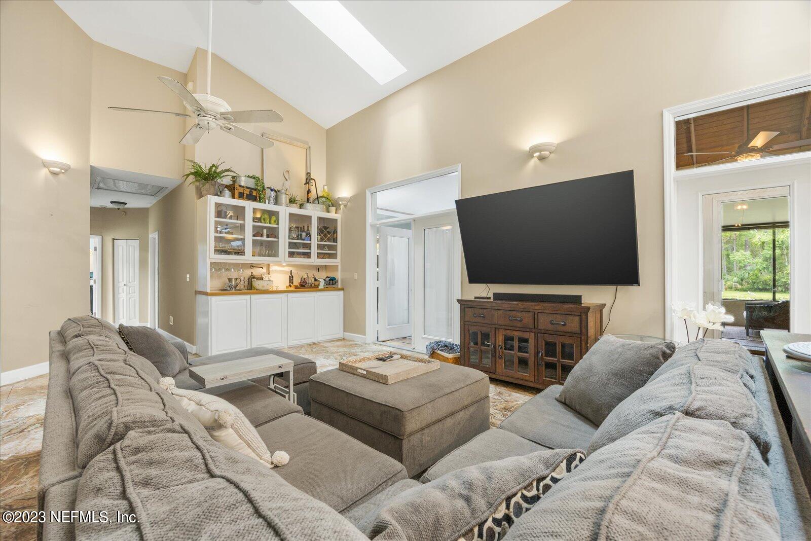 1100 Oak Ridge Road St. Augustine, FL 32086 - Photo 14 of 95 a living room with furniture and a flat screen tv