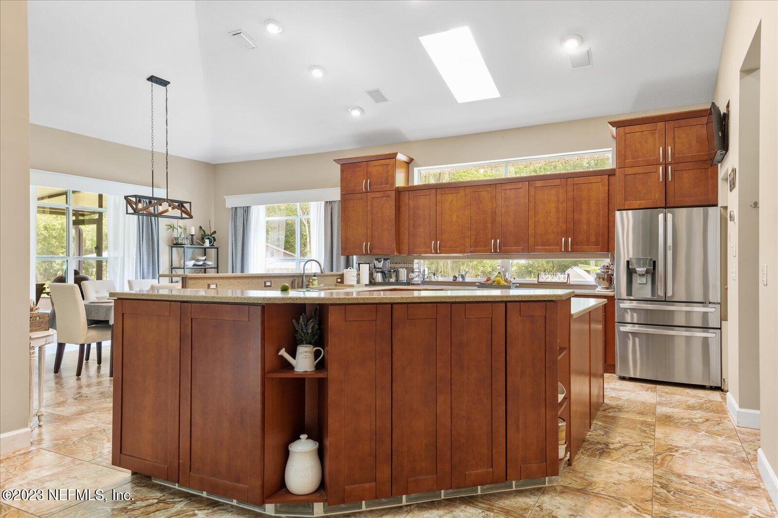 1100 Oak Ridge Road St. Augustine, FL 32086 - Photo 15 of 95 a kitchen with stainless steel appliances granite countertop a refrigerator and wooden cabinets