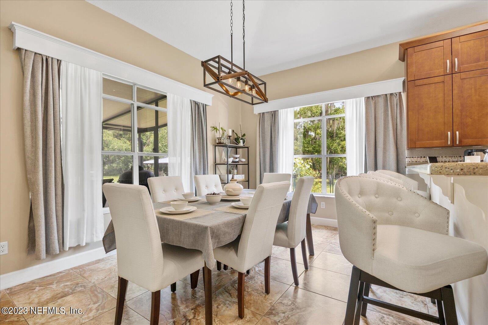 1100 Oak Ridge Road St. Augustine, FL 32086 - Photo 20 of 95 a view of a dining room with furniture window and outside view
