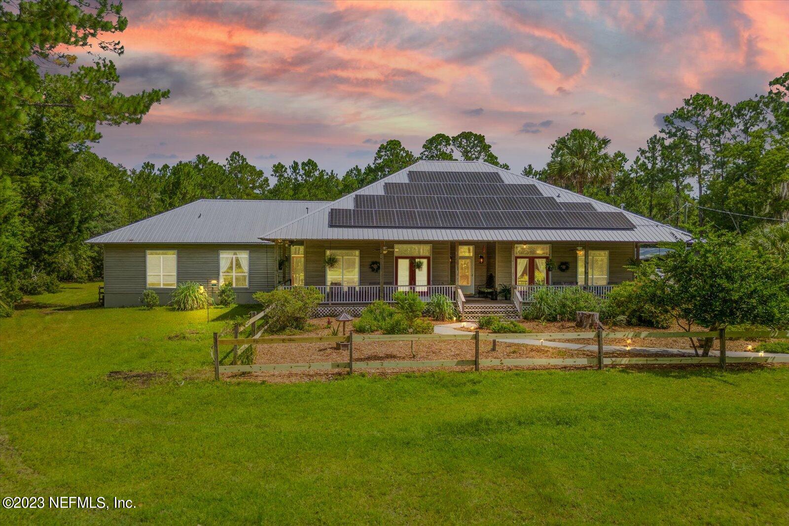 1100 Oak Ridge Road St. Augustine, FL 32086 - Photo 2 of 95 a front view of a house with a garden
