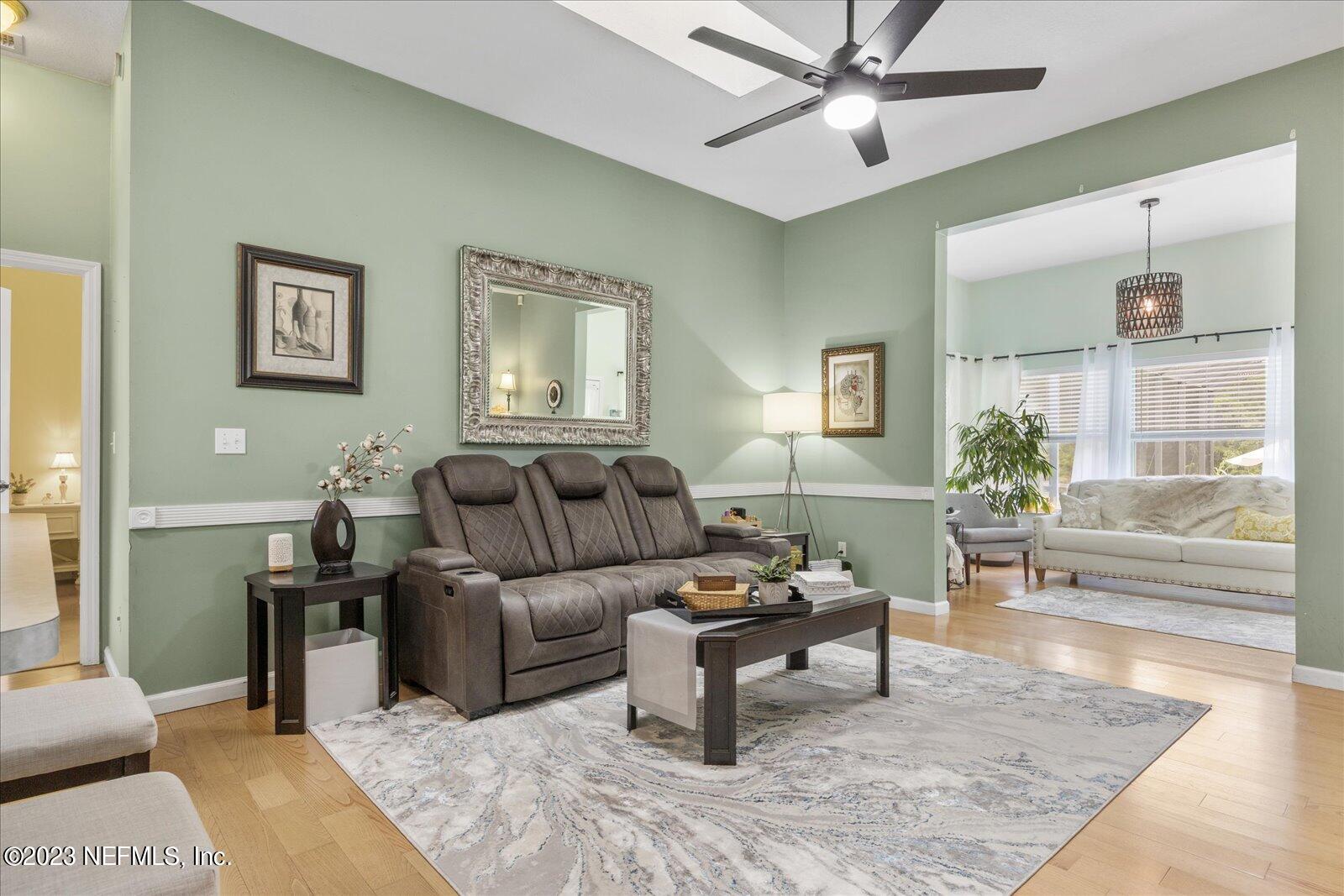 1100 Oak Ridge Road St. Augustine, FL 32086 - Photo 27 of 95 a living room with furniture and a wooden floor
