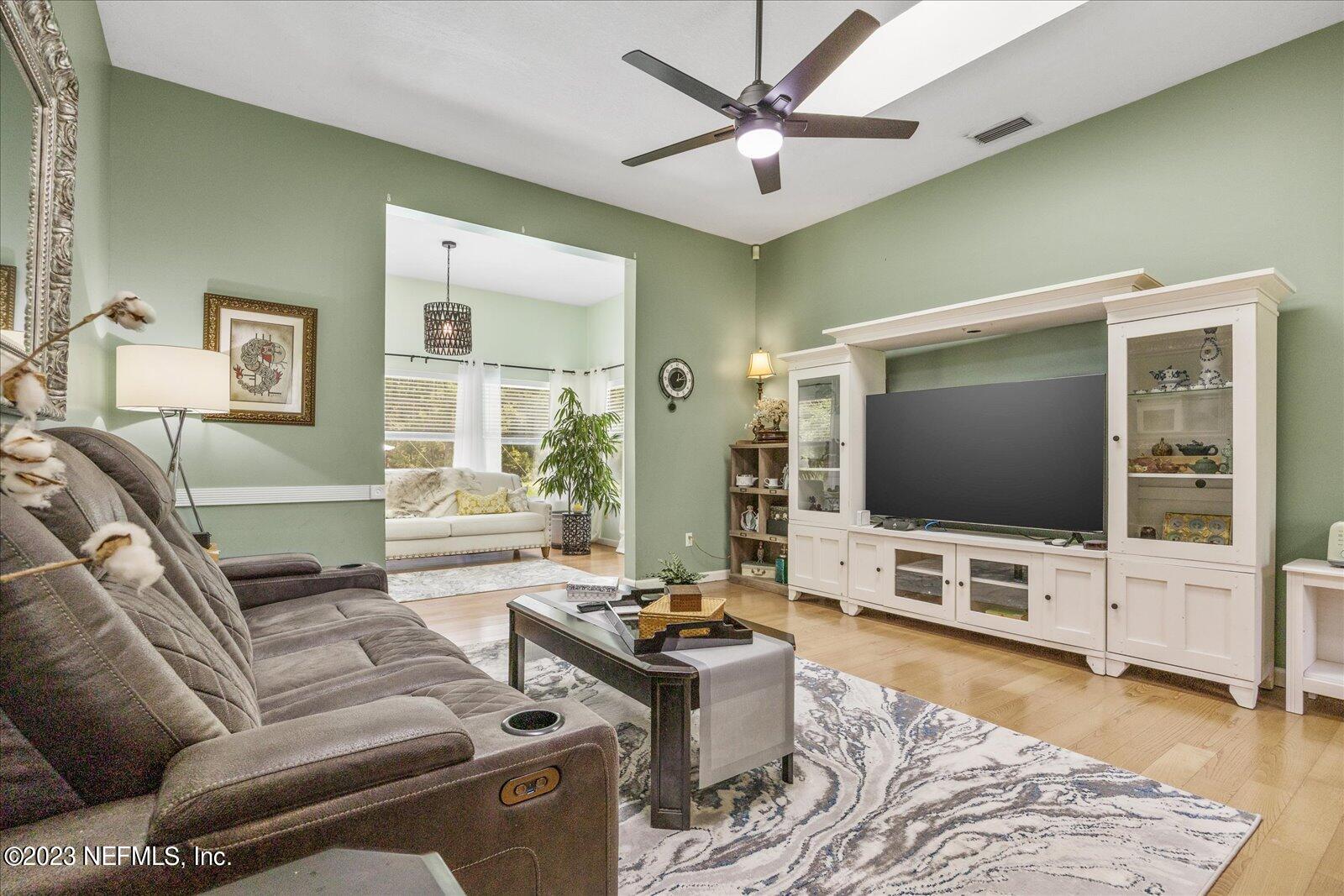 1100 Oak Ridge Road St. Augustine, FL 32086 - Photo 28 of 95 a living room with furniture and a flat screen tv