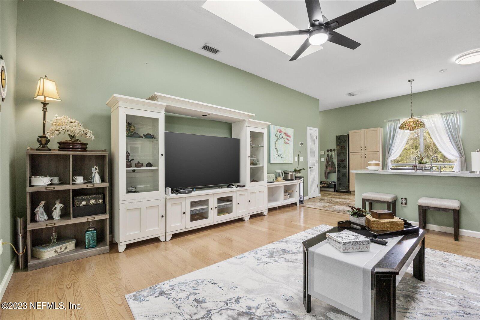 1100 Oak Ridge Road St. Augustine, FL 32086 - Photo 29 of 95 a living room with furniture and a flat screen tv