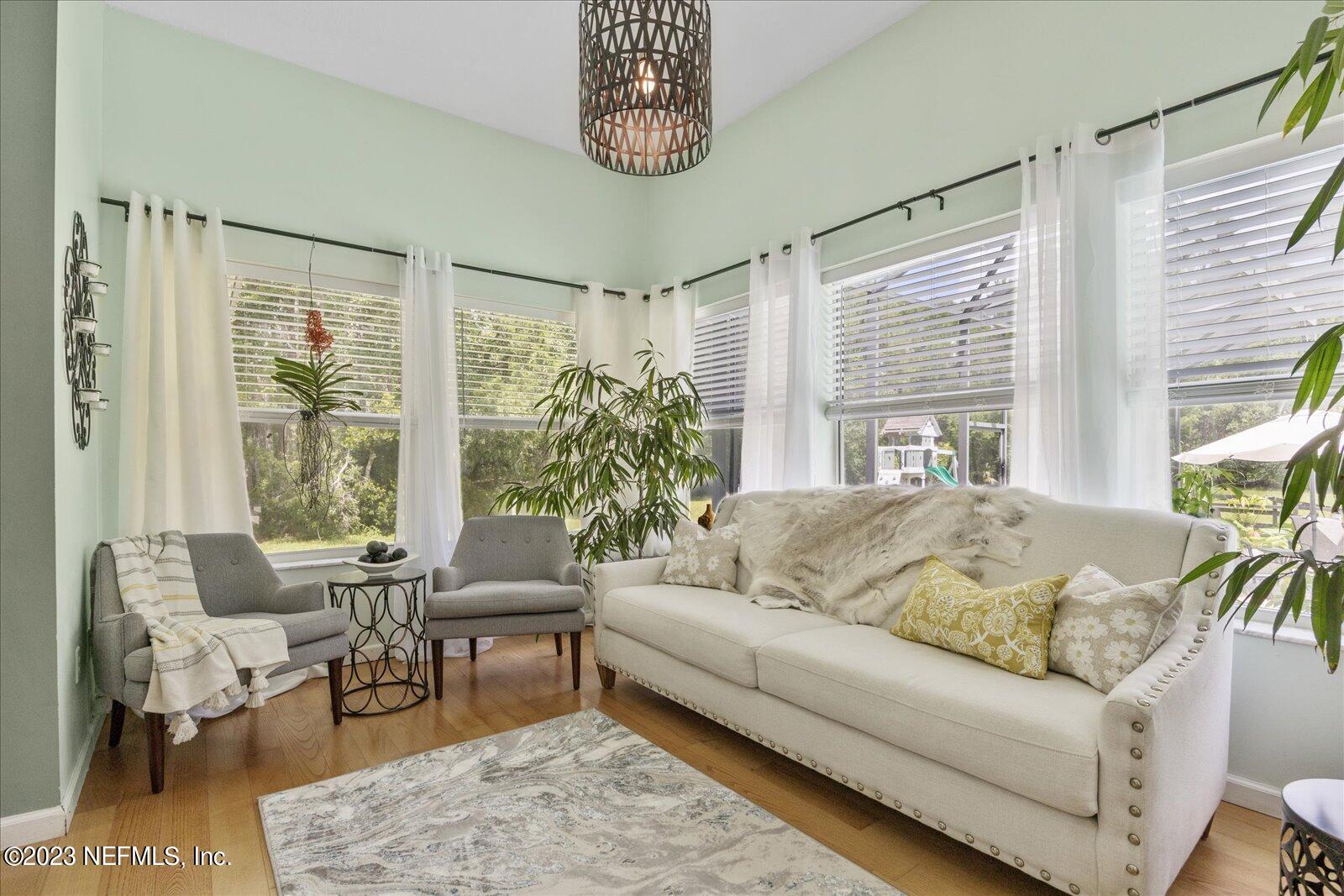 1100 Oak Ridge Road St. Augustine, FL 32086 - Photo 31 of 95 a living room with furniture and a large window