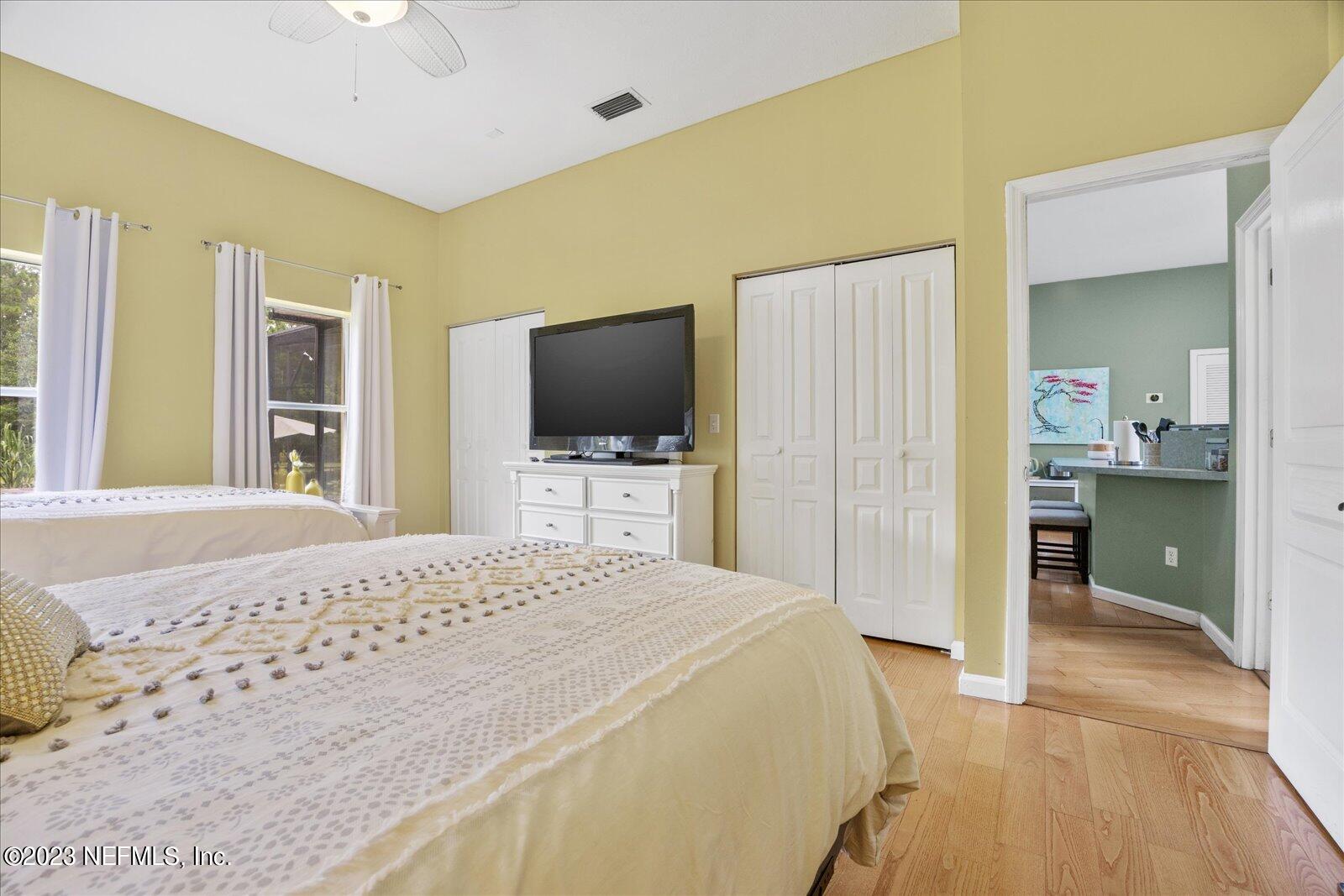 1100 Oak Ridge Road St. Augustine, FL 32086 - Photo 34 of 95 a bedroom with a bed and a flat screen tv
