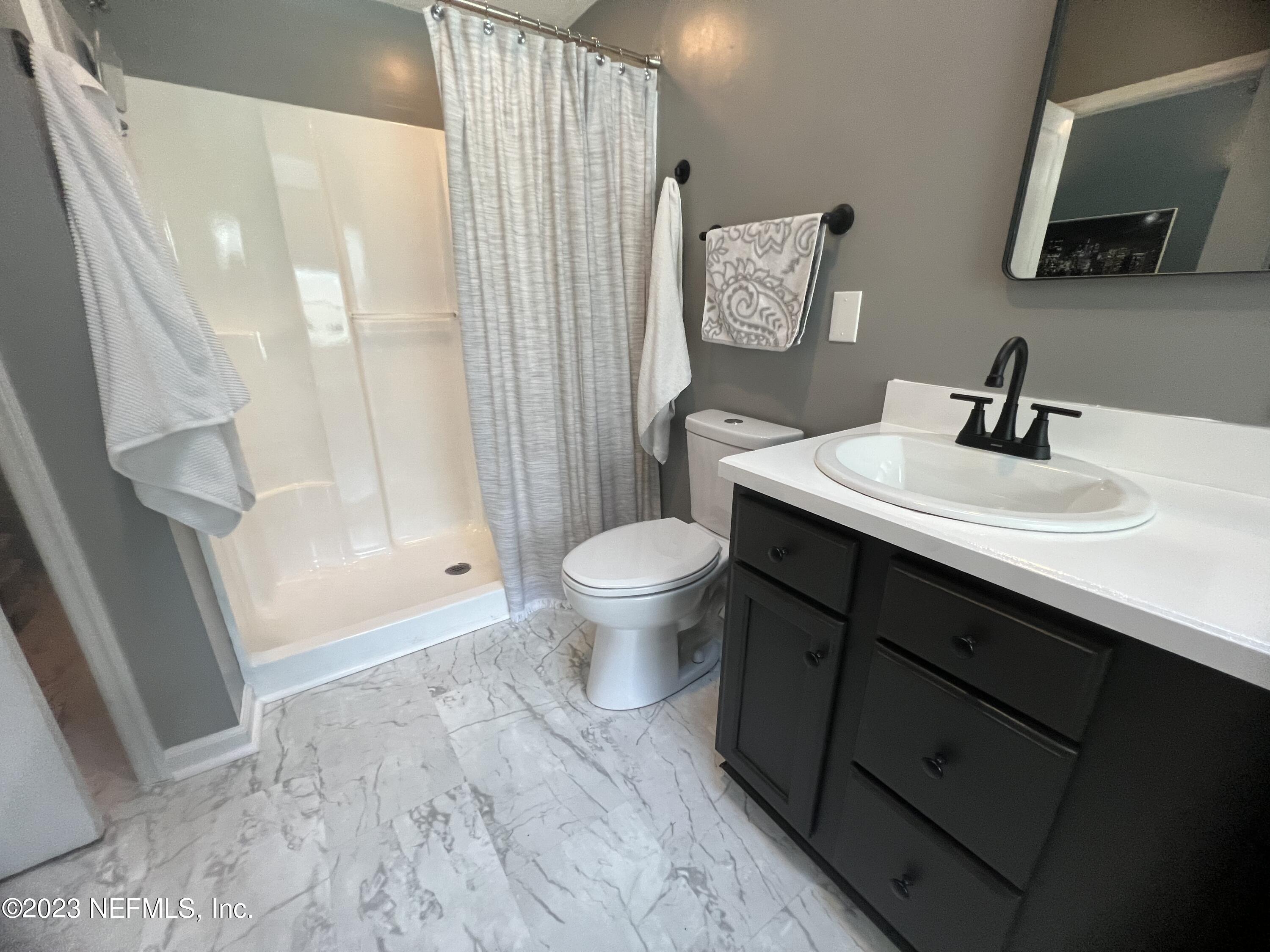 1100 Oak Ridge Road St. Augustine, FL 32086 - Photo 43 of 95 a bathroom with a sink and a mirror
