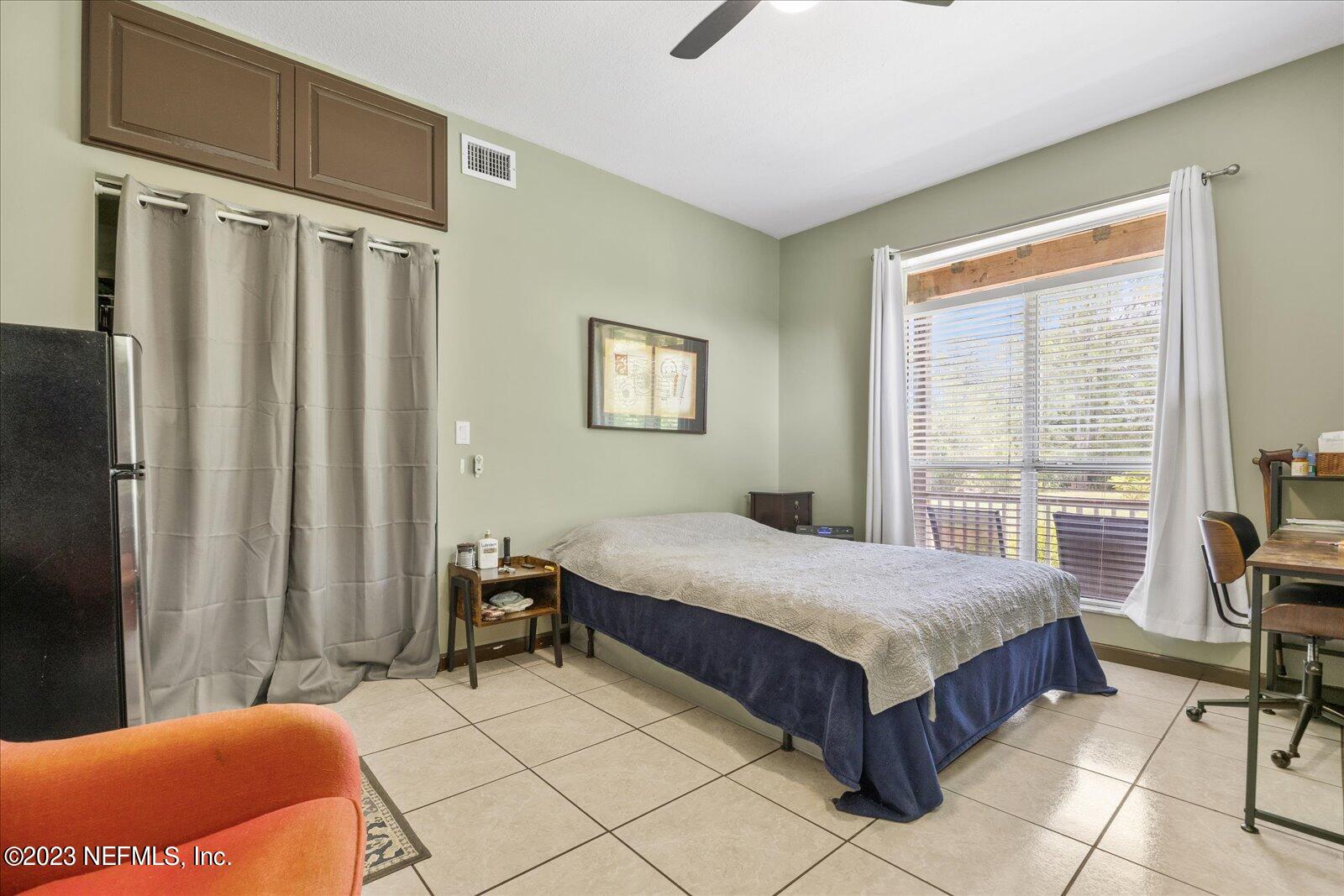 1100 Oak Ridge Road St. Augustine, FL 32086 - Photo 44 of 95 a bedroom with a bed and a table in it