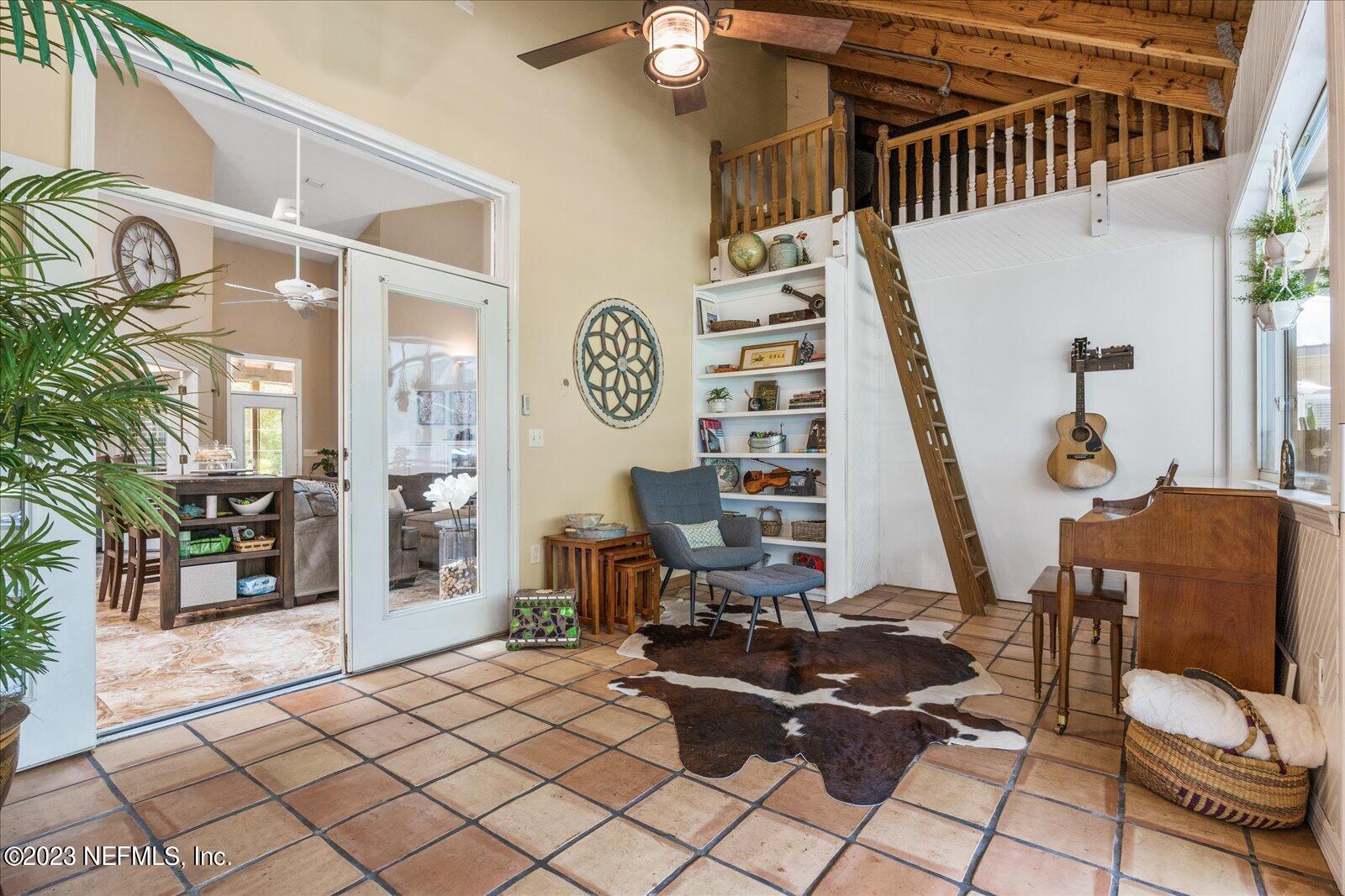 1100 Oak Ridge Road St. Augustine, FL 32086 - Photo 50 of 95 a living room with furniture and wooden floor