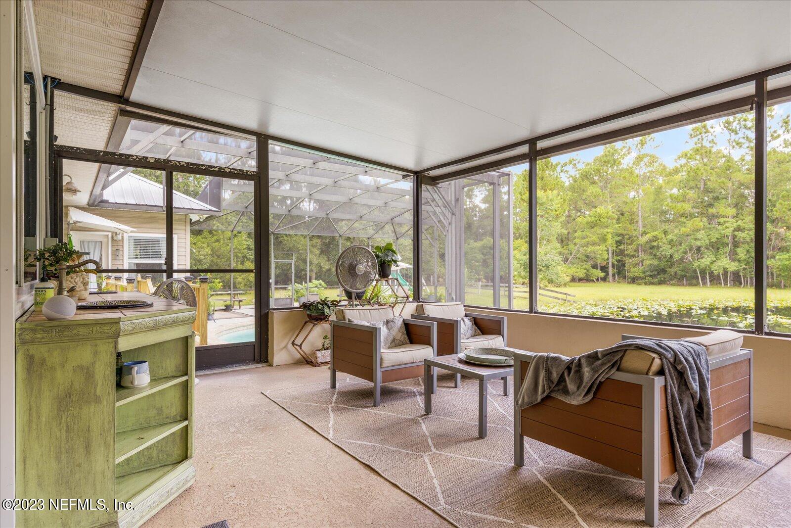 1100 Oak Ridge Road St. Augustine, FL 32086 - Photo 56 of 95 a living room with furniture and a large window