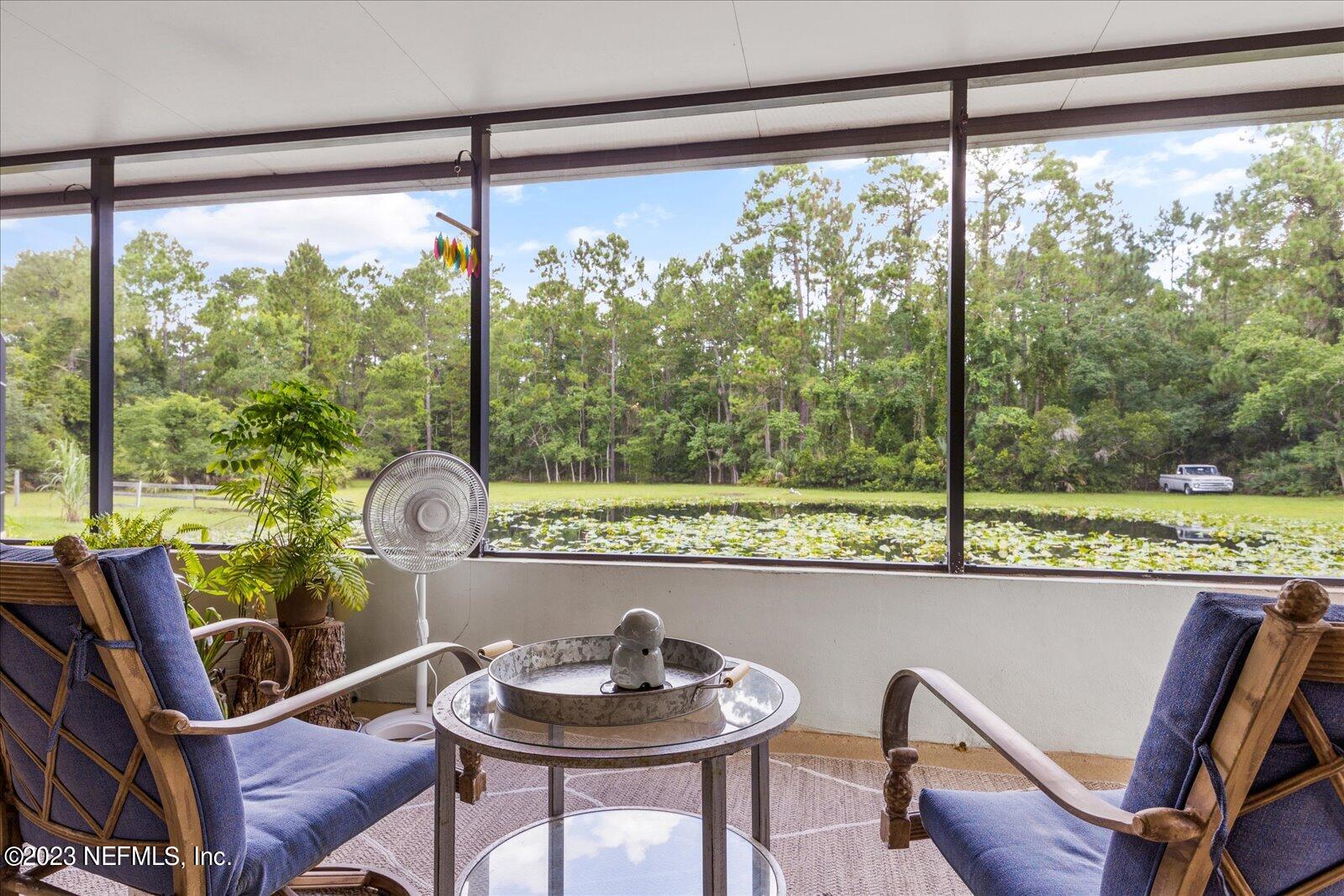 1100 Oak Ridge Road St. Augustine, FL 32086 - Photo 59 of 95 a dining room with furniture window and outside view