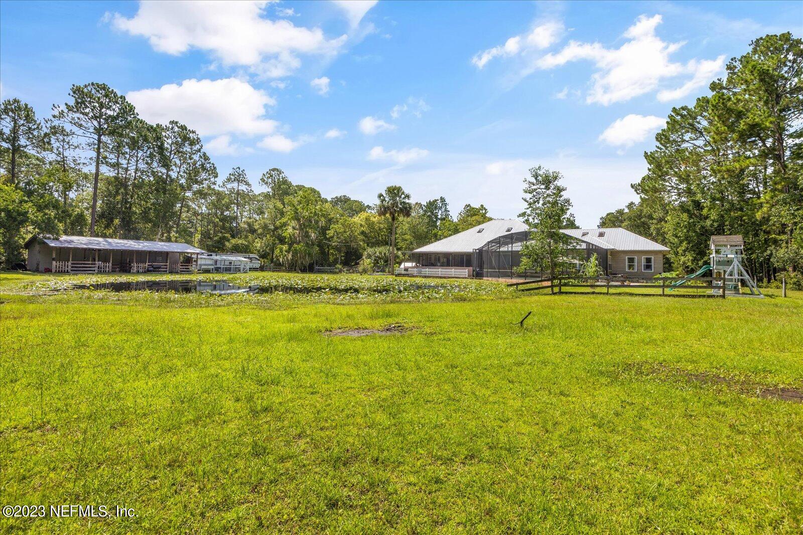 1100 Oak Ridge Road St. Augustine, FL 32086 - Photo 67 of 95 a view of a swimming pool with an outdoor space and seating area