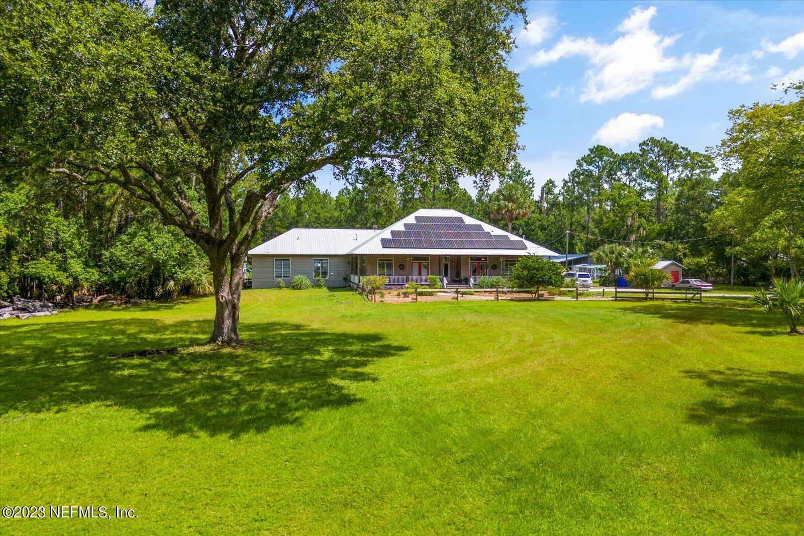 1100 Oak Ridge Road St. Augustine, FL 32086 - Photo 7 of 95 a view of swimming pool with lawn chairs under an umbrella