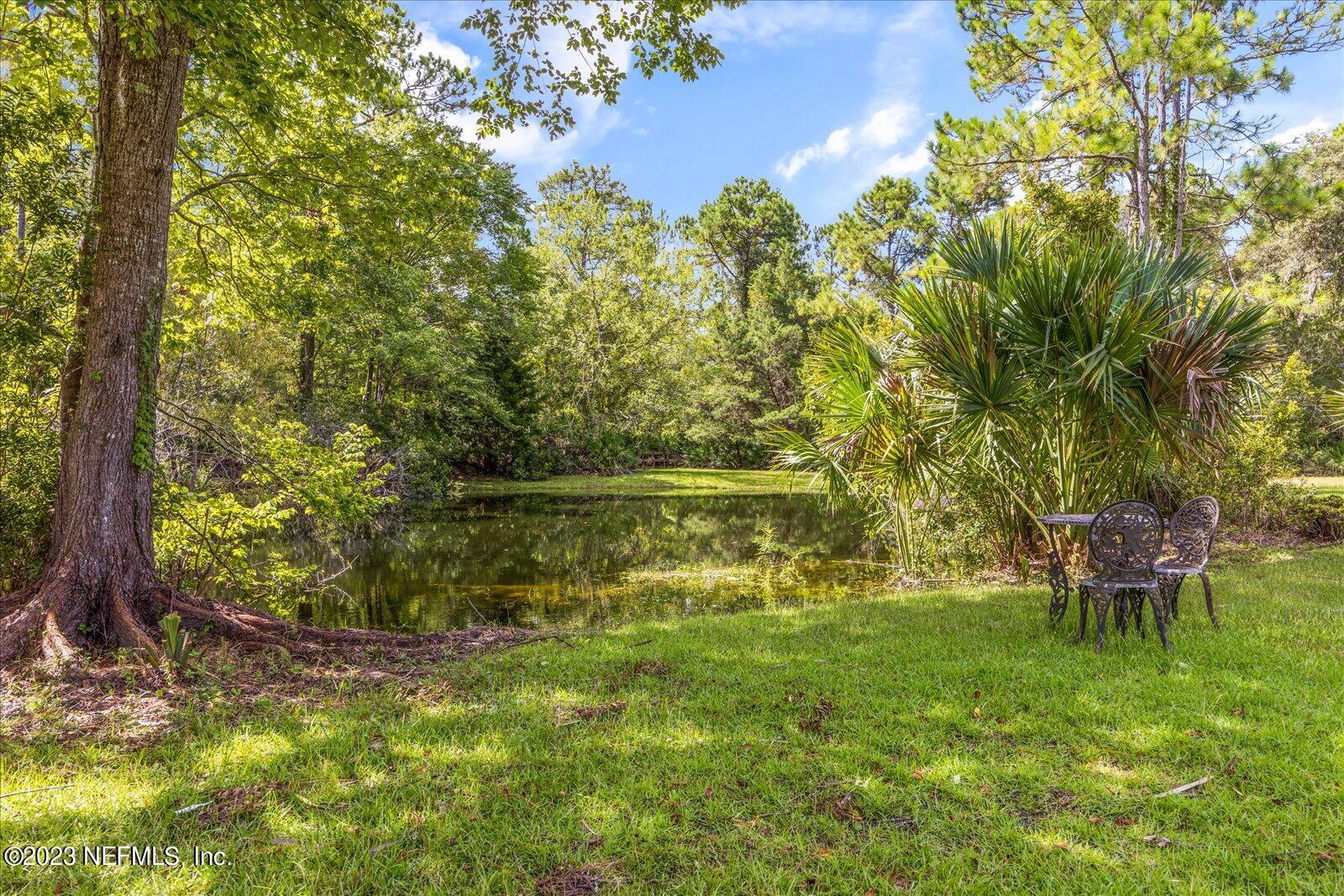 1100 Oak Ridge Road St. Augustine, FL 32086 - Photo 83 of 95 a backyard of a house with table and chairs