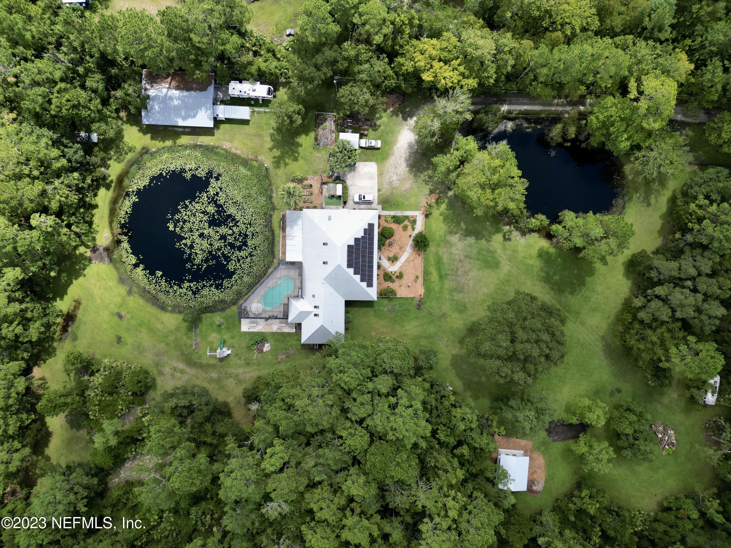 1100 Oak Ridge Road St. Augustine, FL 32086 - Photo 92 of 95 an aerial view of a house with pool yard outdoor seating and yard
