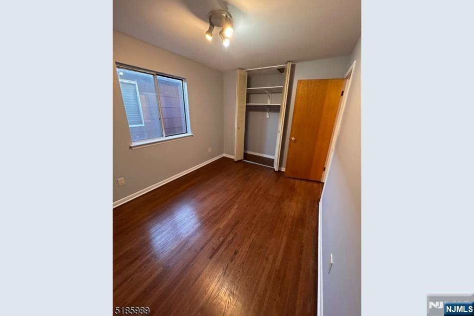 736 William Street, Unit 2 Harrison, NJ 07029 - Photo 11 of 13 an empty room with wooden floor and windows