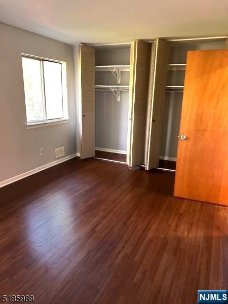 736 William Street, Unit 2 Harrison, NJ 07029 - Photo 5 of 13 an empty room with wooden floor and windows