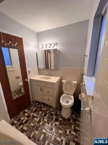 a bathroom with a sink toilet and mirror