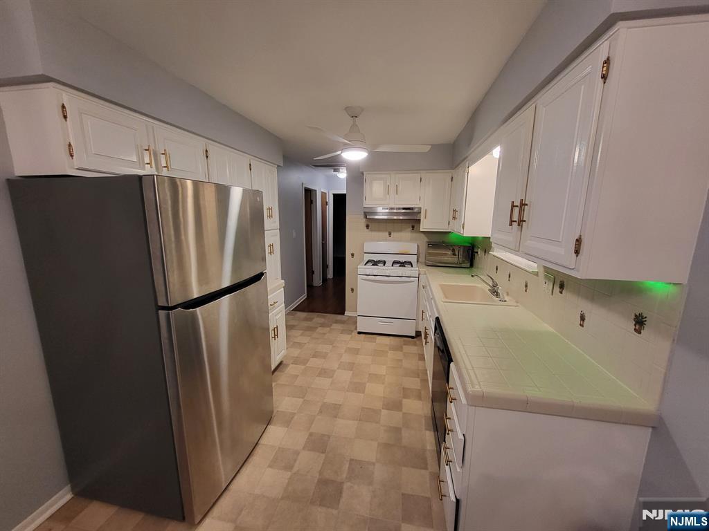 736 William Street, Unit 2 Harrison, NJ 07029 - Photo 10 of 13 a kitchen with stainless steel appliances a refrigerator sink and cabinets