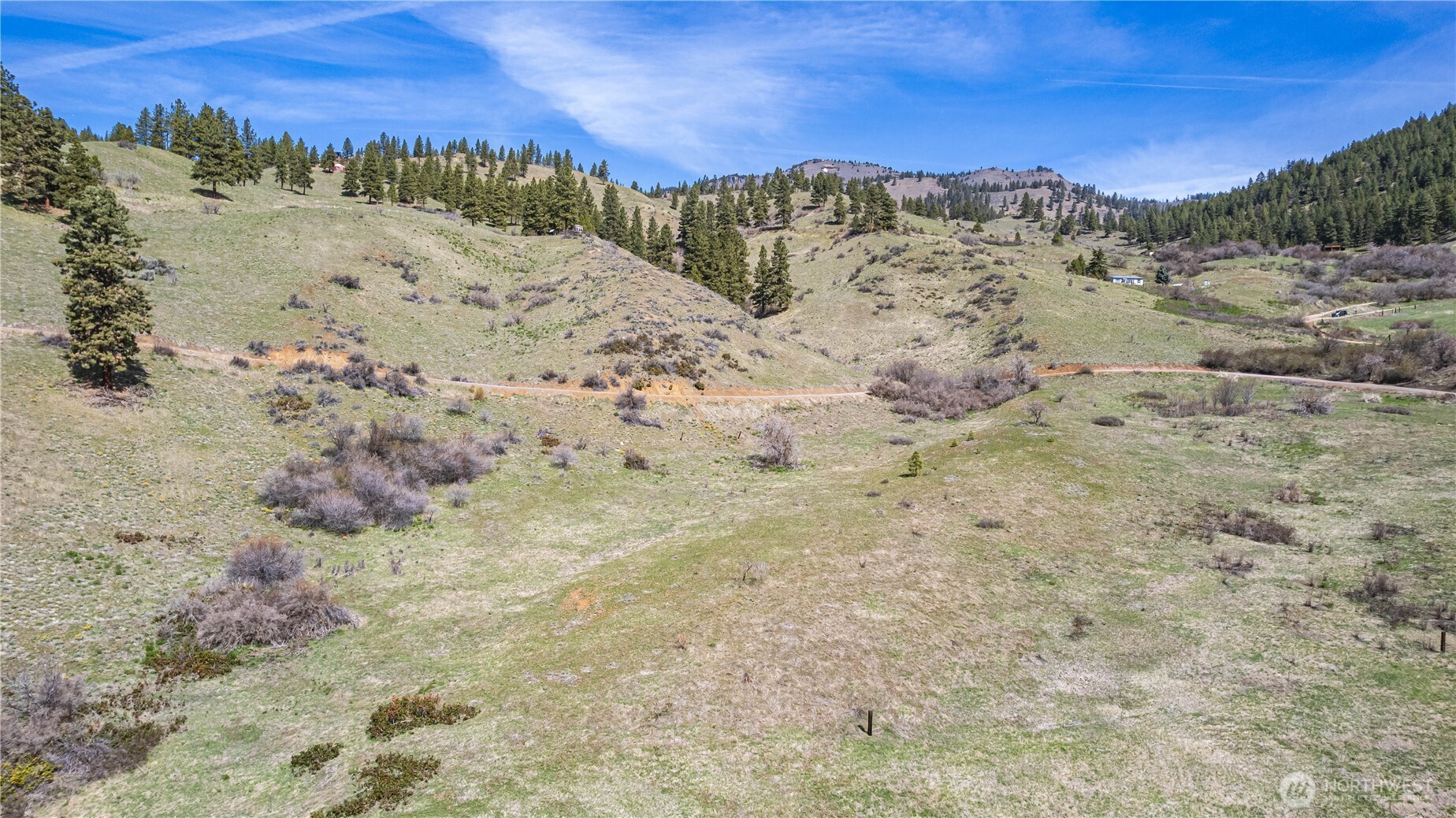 9640 Nahahum Canyon Road Cashmere, WA 98815 - Photo 7 of 25 a view of a dry field with mountains in the background