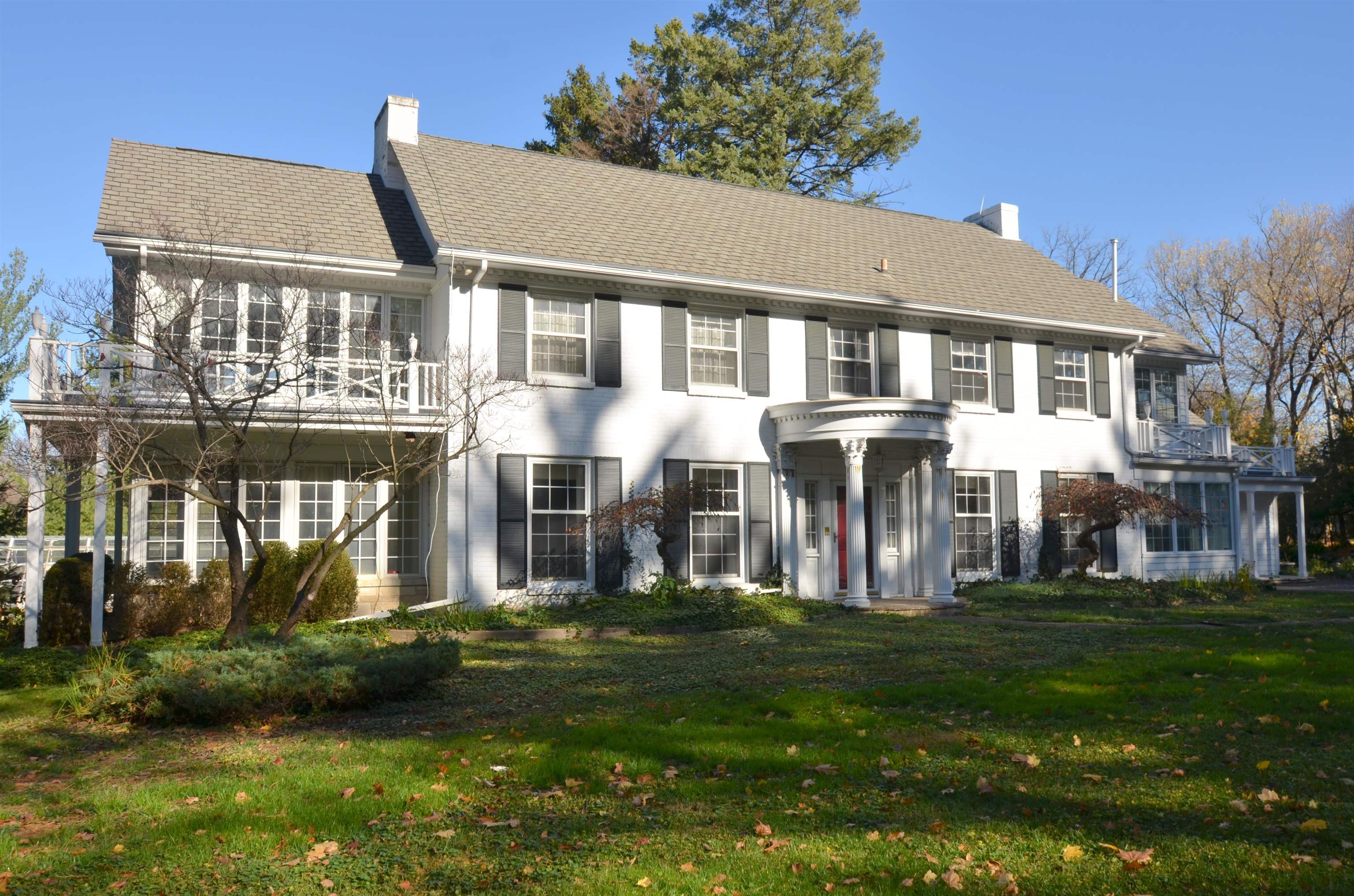 4980 Spring Brook Road Rockford, IL 61114 - Photo 1 of 50 a front view of a house with a garden and trees