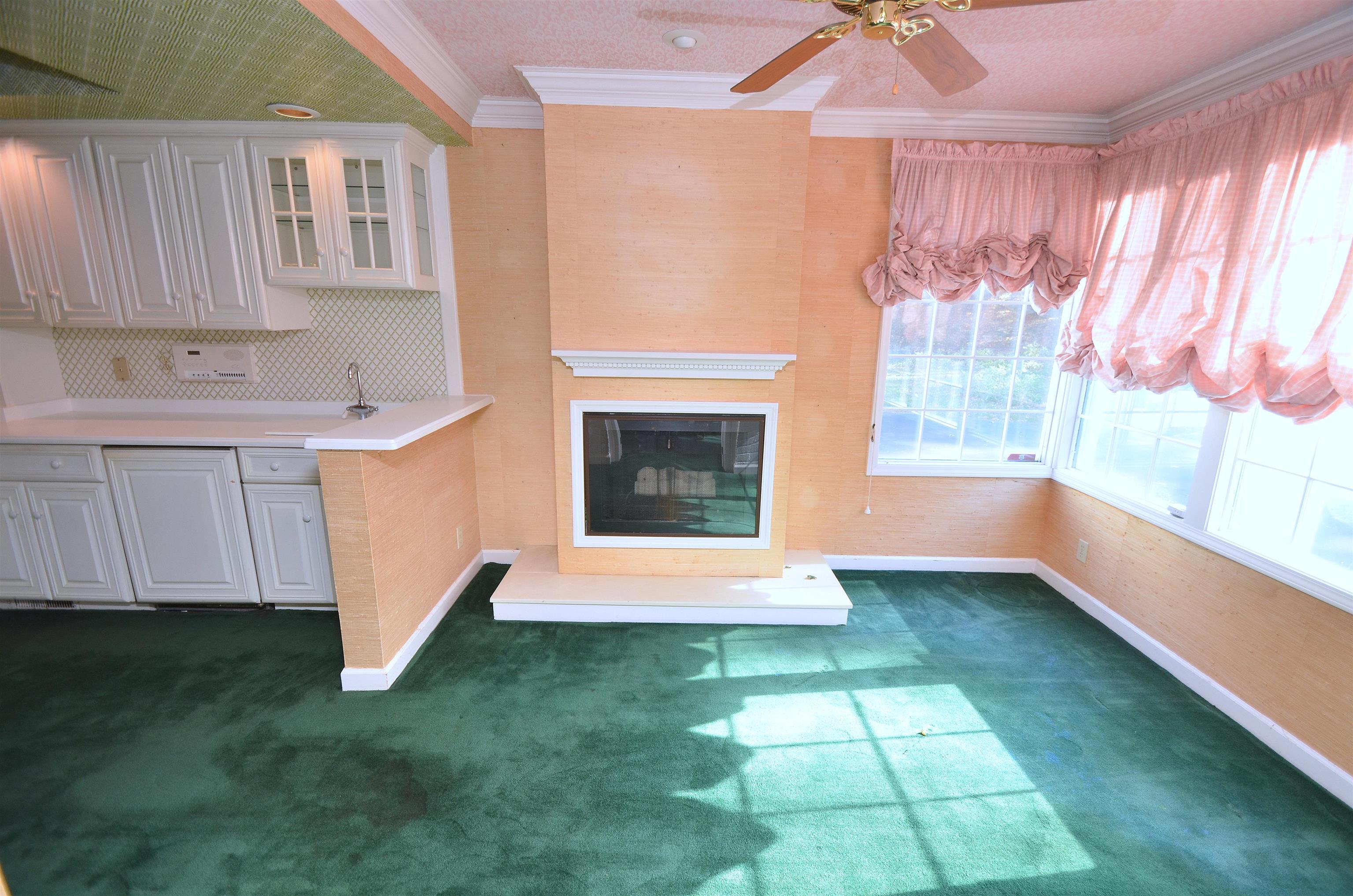4980 Spring Brook Road Rockford, IL 61114 - Photo 13 of 50 a view of an empty room with a fireplace and a window