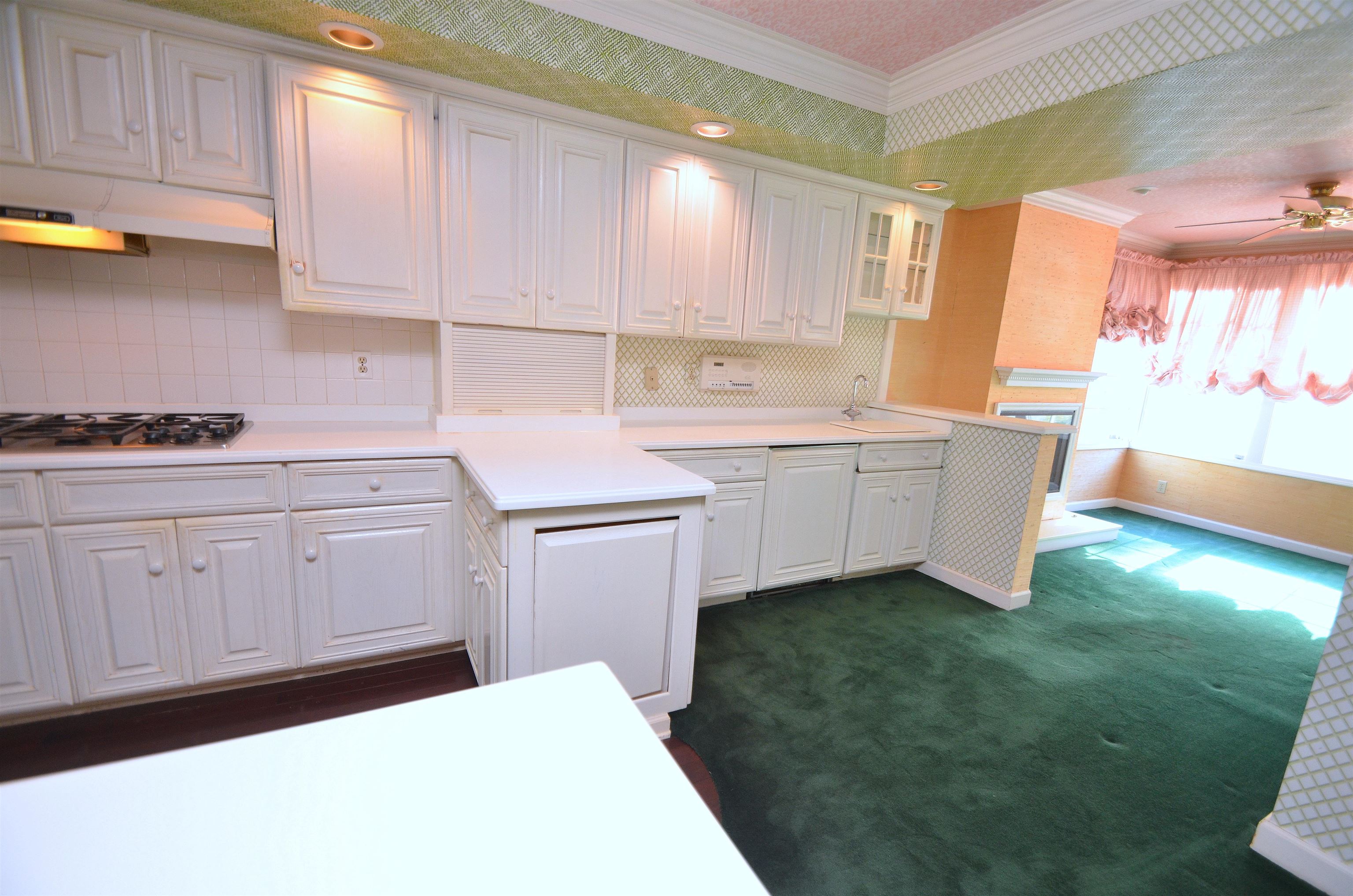 4980 Spring Brook Road Rockford, IL 61114 - Photo 15 of 50 a kitchen with a sink dishwasher and white cabinets with wooden floor