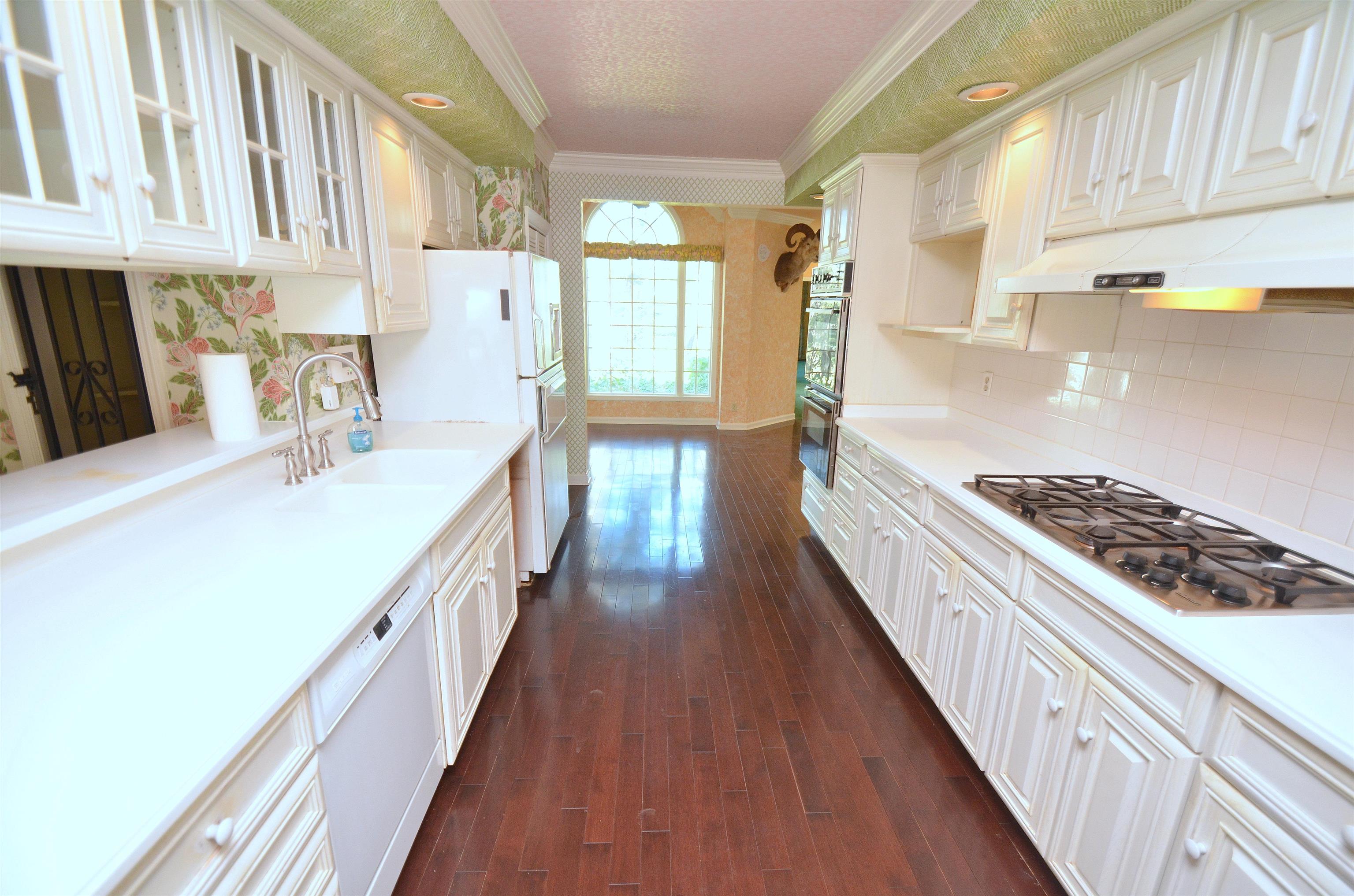 4980 Spring Brook Road Rockford, IL 61114 - Photo 17 of 50 a kitchen with stainless steel appliances a stove and a wooden floors