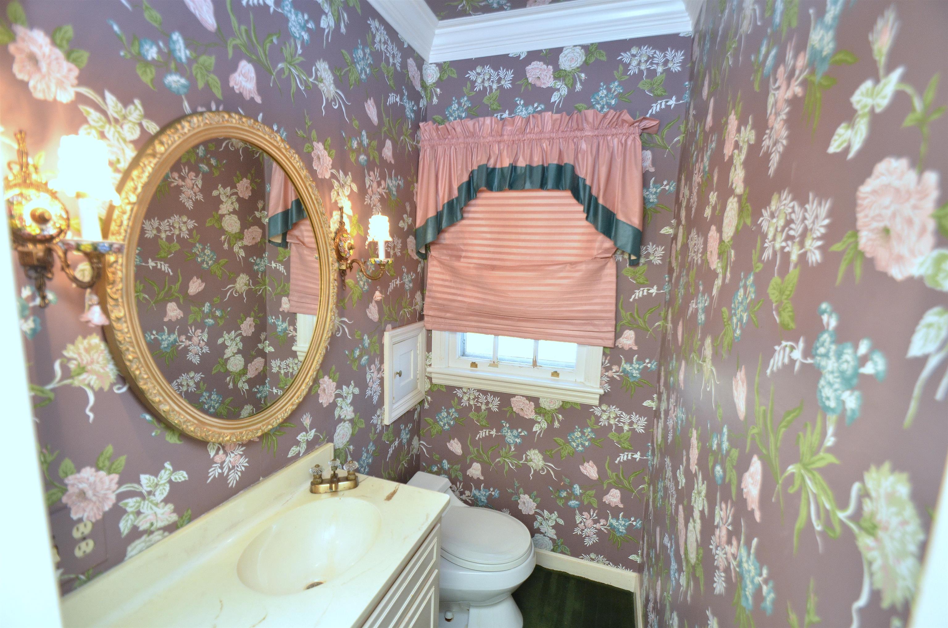 4980 Spring Brook Road Rockford, IL 61114 - Photo 22 of 50 a bathroom with a toilet sink and mirror