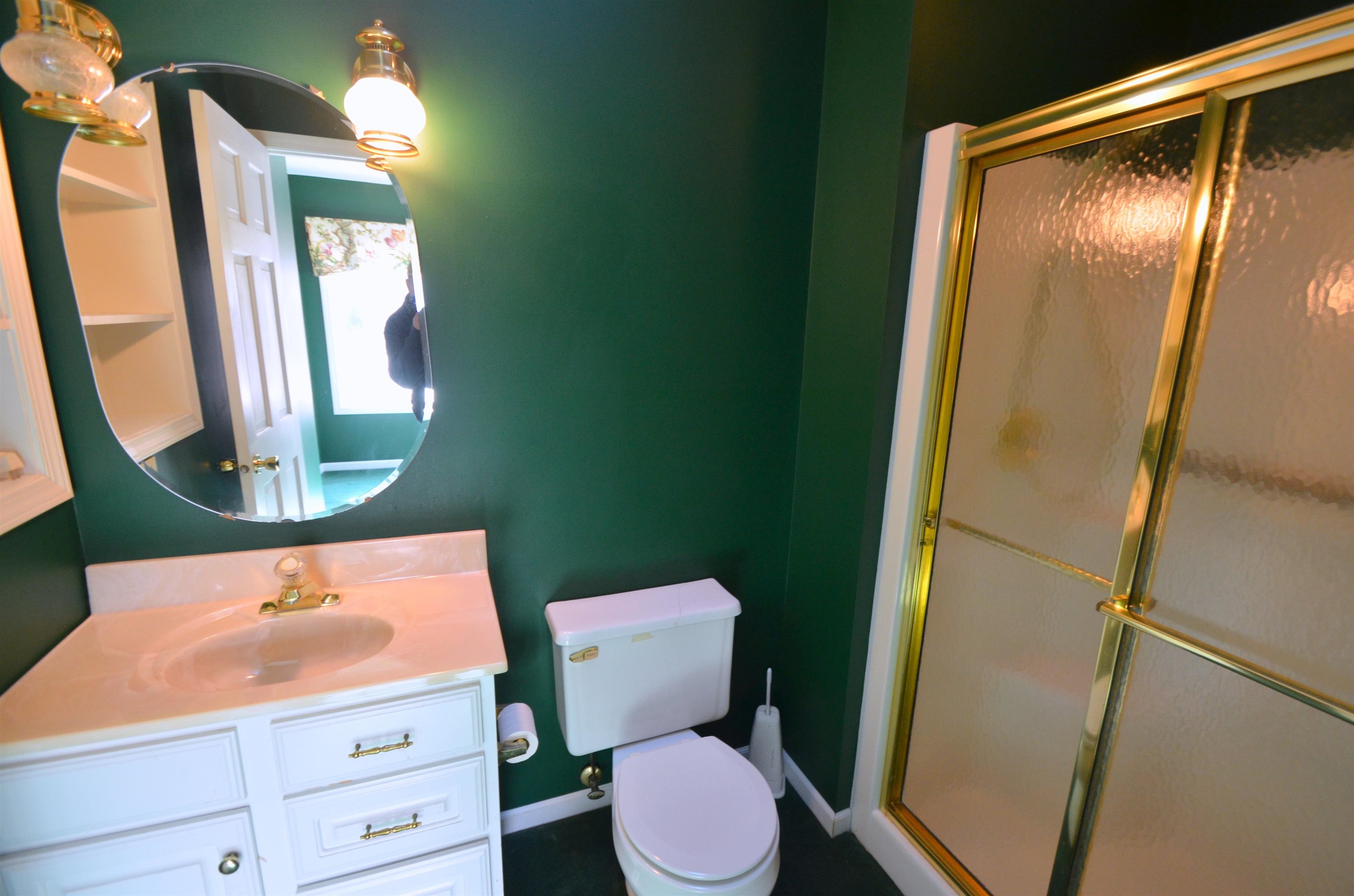 4980 Spring Brook Road Rockford, IL 61114 - Photo 41 of 50 a bathroom with a toilet a sink and a mirror